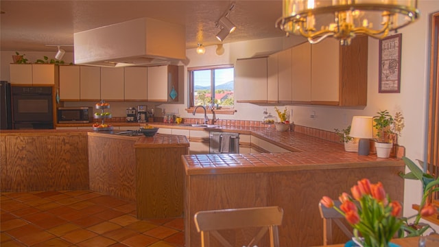 7 Paseo De Rincon, Santa Fe, NM 87508 - kitchen featuring appliances with stainless steel finishes, rail lighting, tile counters, custom exhaust hood, and light tile patterned flooring