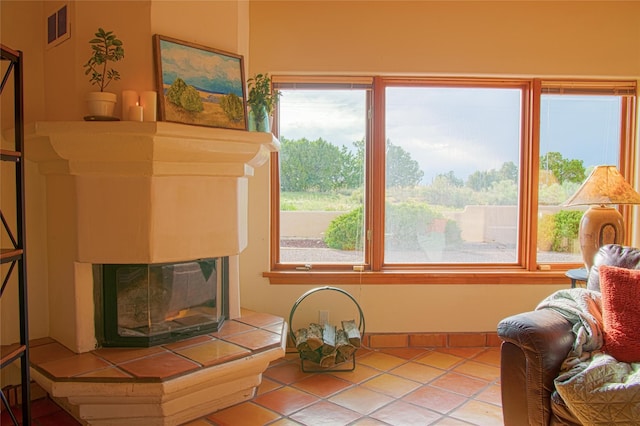 7 Paseo De Rincon, Santa Fe, NM 87508 - living area featuring plenty of natural light, a fireplace, and tile patterned floors