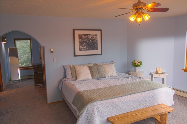 7 Paseo De Rincon, Santa Fe, NM 87508 - bedroom featuring carpet flooring, arched walkways, ceiling fan, and baseboard heating