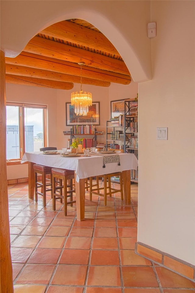 7 Paseo De Rincon, Santa Fe, NM 87508 - dining area with arched walkways, a wooden ceiling with exposed beams, and a chandelier