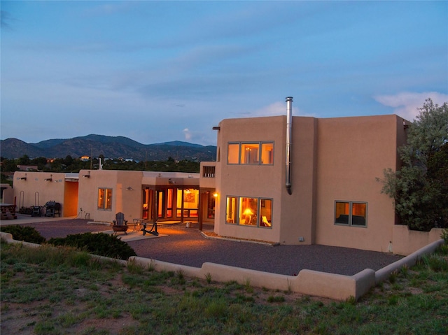 7 Paseo De Rincon, Santa Fe, NM 87508 - back of house with a patio, a mountain view, and stucco siding