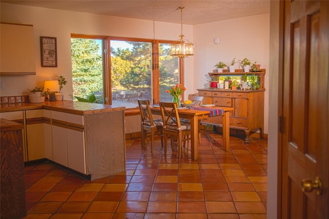 7 Paseo De Rincon, Santa Fe, NM 87508 - dining area featuring a chandelier, a textured ceiling, and light tile patterned flooring