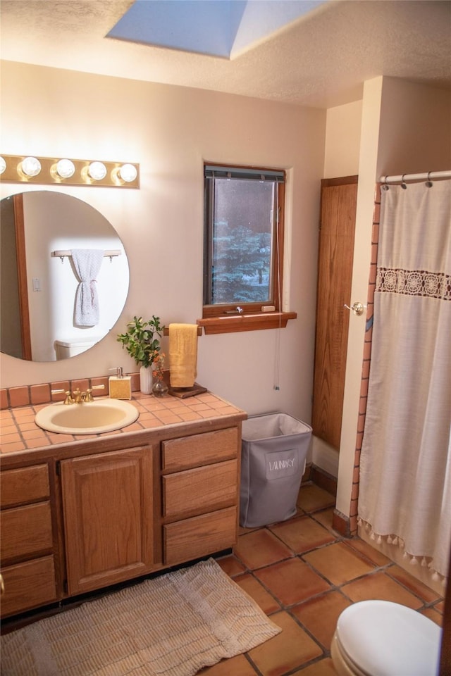 7 Paseo De Rincon, Santa Fe, NM 87508 - bathroom featuring vanity, a shower with curtain, tile patterned flooring, and a skylight