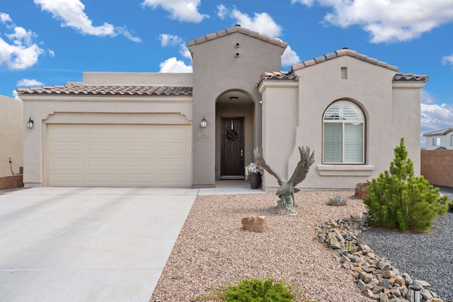 6816 Cleary Loop NE, Rio Rancho, NM 87144 - mediterranean / spanish-style home featuring a tiled roof, driveway, a garage, and stucco siding