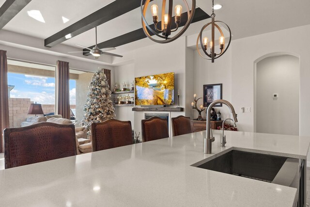 6816 Cleary Loop NE, Rio Rancho, NM 87144 - kitchen featuring arched walkways, a chandelier, open floor plan, light countertops, and beamed ceiling