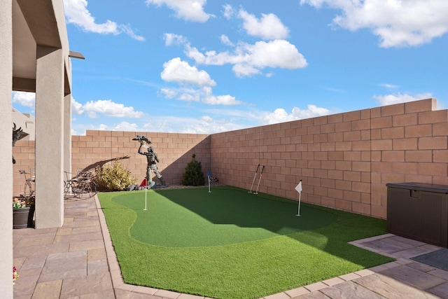 6816 Cleary Loop NE, Rio Rancho, NM 87144 - fenced backyard featuring a putting area and a patio