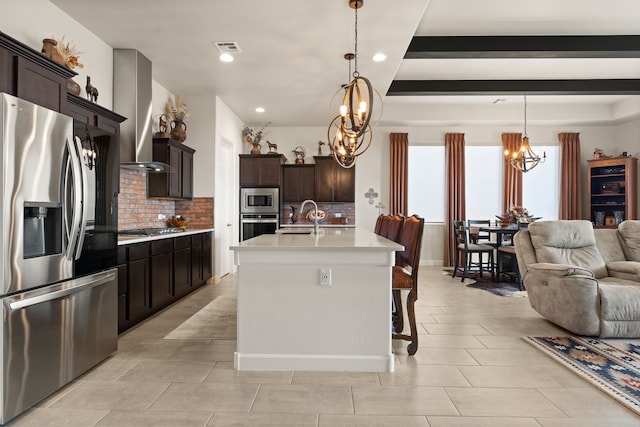 6816 Cleary Loop NE, Rio Rancho, NM 87144 - kitchen featuring stainless steel appliances, a chandelier, open floor plan, tasteful backsplash, and recessed lighting
