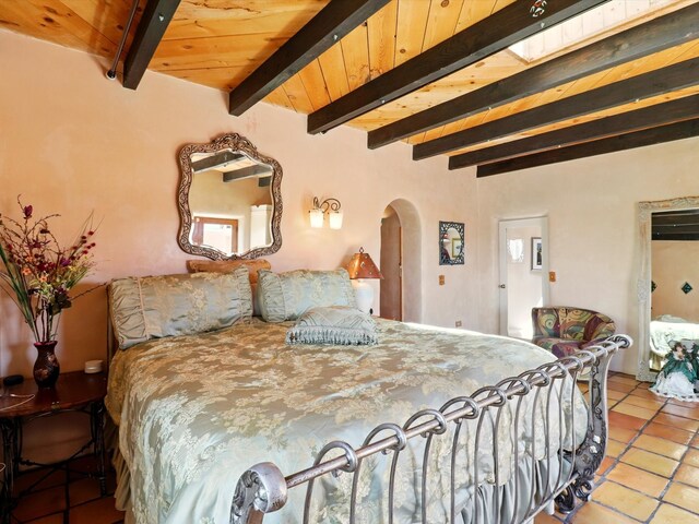 31AB Hondo Trl, Santa Fe, NM 87508 - tiled bedroom with arched walkways and beamed ceiling