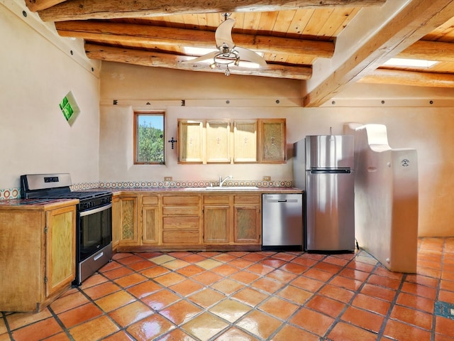 31AB Hondo Trl, Santa Fe, NM 87508 - kitchen featuring appliances with stainless steel finishes, light tile patterned floors, a ceiling fan, a wood ceiling with exposed beams, and light countertops
