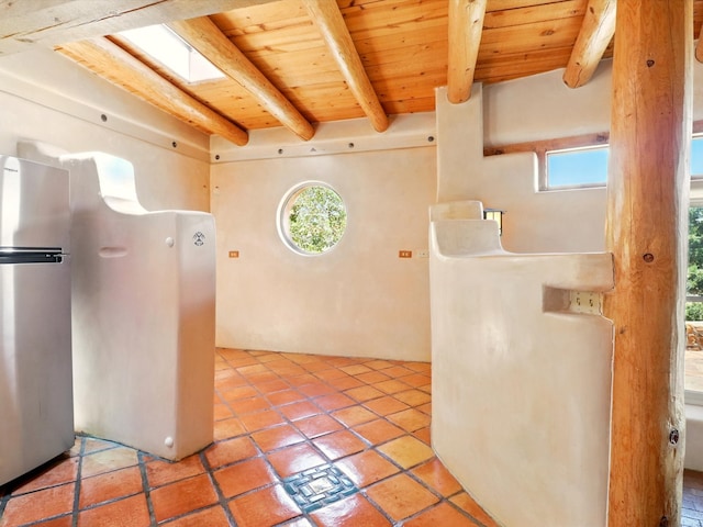 31AB Hondo Trl, Santa Fe, NM 87508 - kitchen featuring a wood ceiling with exposed beams, healthy amount of natural light, freestanding refrigerator, and tile patterned floors