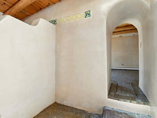 31AB Hondo Trl, Santa Fe, NM 87508 - spare room featuring arched walkways, a wooden ceiling with exposed beams, and baseboard heating