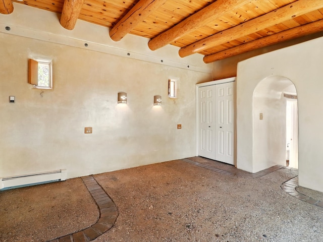 31AB Hondo Trl, Santa Fe, NM 87508 - empty room featuring a wooden ceiling with exposed beams, a baseboard heating unit, and arched walkways