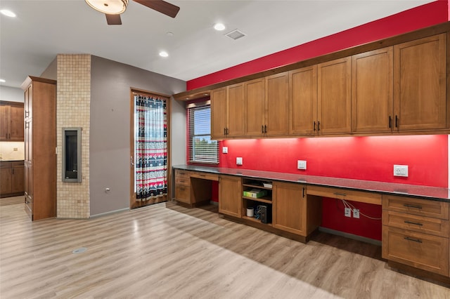 46 Oshara Blvd, Santa Fe, NM 87508 - kitchen featuring built in desk, light wood-style floors, ceiling fan, brown cabinets, and recessed lighting