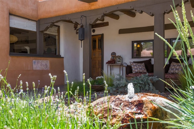 576 Camino Del Monte Sol, Santa Fe, NM 87505 - doorway to property with stucco siding and a ceiling fan