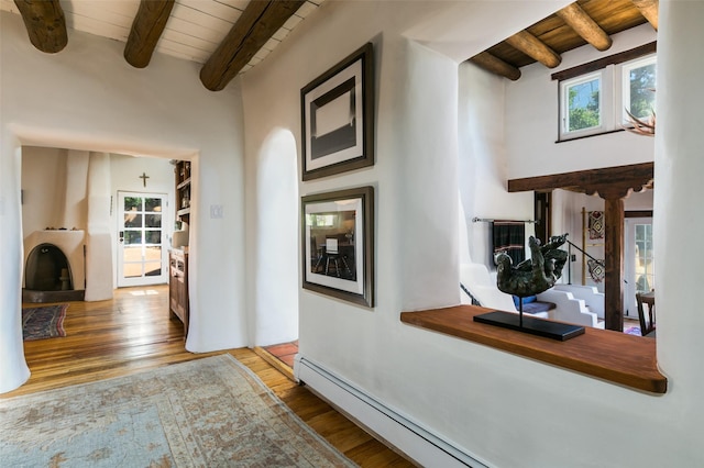 576 Camino Del Monte Sol, Santa Fe, NM 87505 - hall with a wooden ceiling with exposed beams, wood finished floors, a baseboard heating unit, and a high ceiling