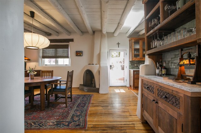 576 Camino Del Monte Sol, Santa Fe, NM 87505 - dining area with light wood-type flooring and a wooden ceiling with exposed beams