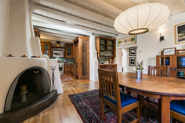 576 Camino Del Monte Sol, Santa Fe, NM 87505 - dining space with light wood finished floors and arched walkways