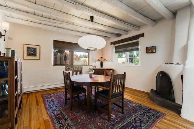 576 Camino Del Monte Sol, Santa Fe, NM 87505 - dining area with a baseboard heating unit, a wood ceiling with exposed beams, and hardwood / wood-style floors