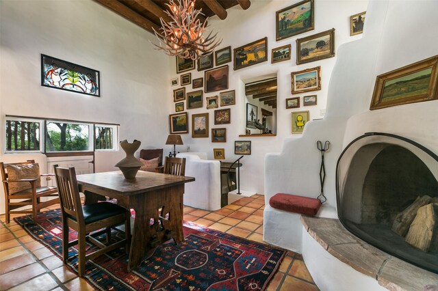 576 Camino Del Monte Sol, Santa Fe, NM 87505 - tiled dining area featuring a high ceiling, a chandelier, and beam ceiling