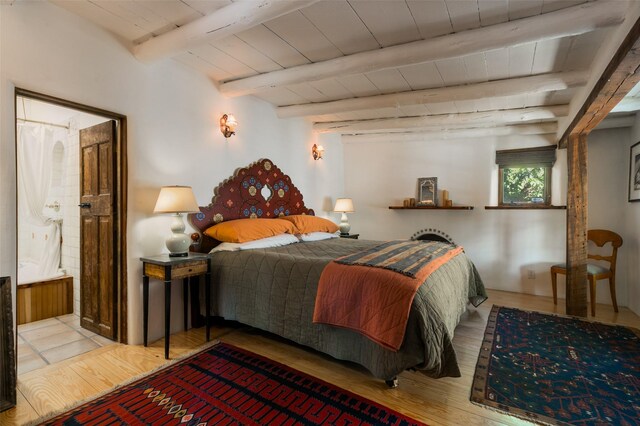 576 Camino Del Monte Sol, Santa Fe, NM 87505 - bedroom with wood finished floors, a wooden ceiling with exposed beams, and connected bathroom