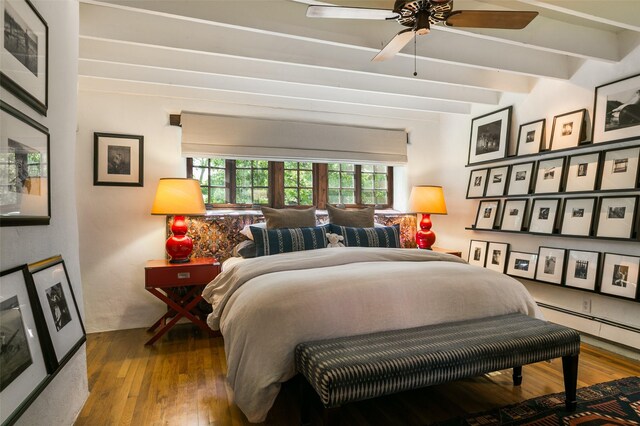 576 Camino Del Monte Sol, Santa Fe, NM 87505 - bedroom with wood-type flooring, beamed ceiling, and a baseboard radiator