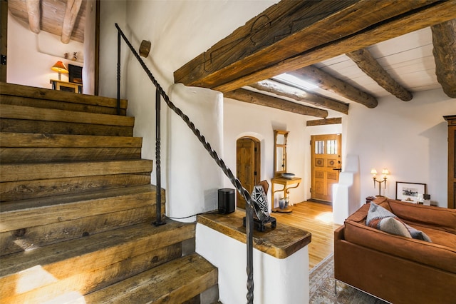 576 Camino Del Monte Sol, Santa Fe, NM 87505 - stairs featuring wood finished floors, arched walkways, and a wood ceiling with exposed beams