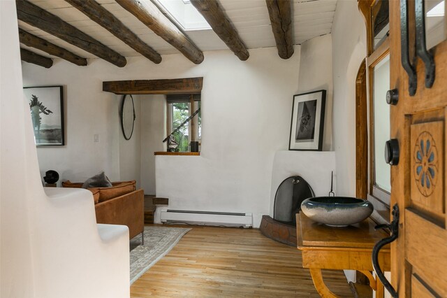 576 Camino Del Monte Sol, Santa Fe, NM 87505 - living area with baseboard heating, beamed ceiling, and wood finished floors