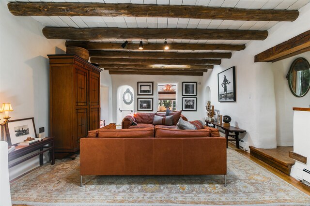 576 Camino Del Monte Sol, Santa Fe, NM 87505 - living room featuring light wood-type flooring, beam ceiling, and arched walkways