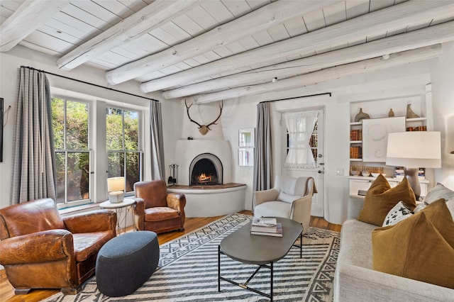 507 Acequia Madre, Santa Fe, NM 87505 - living room featuring wood finished floors, a wooden ceiling with exposed beams, and a lit fireplace