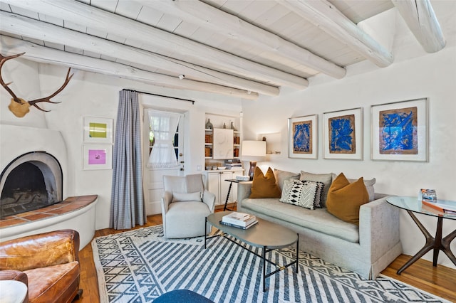 507 Acequia Madre, Santa Fe, NM 87505 - living area with wood finished floors, beam ceiling, and a fireplace with raised hearth