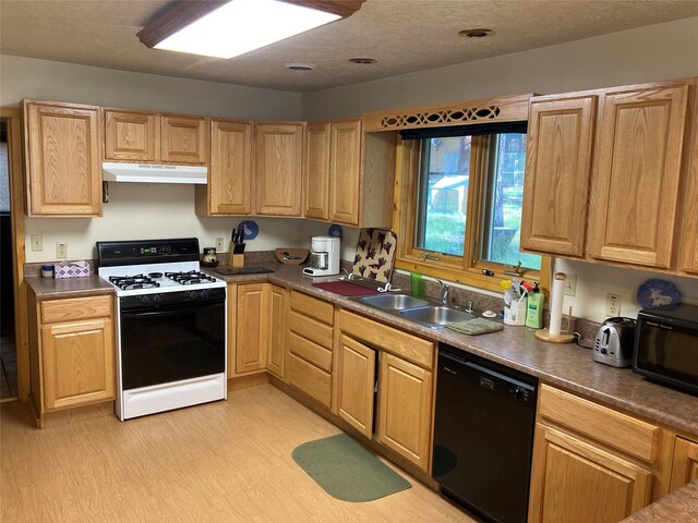 9 Bear Rd, Chama, NM 87520 - kitchen featuring black appliances, under cabinet range hood, light wood-type flooring, and dark countertops