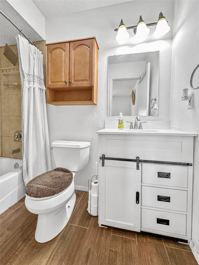 3301 Camino Prado Vis, Santa Fe, NM 87507 - bathroom with vanity, shower / bath combination with curtain, a textured ceiling, and wood finished floors