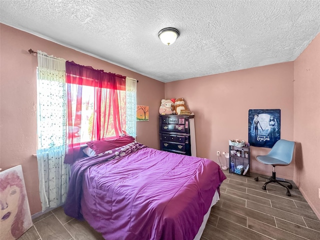 3301 Camino Prado Vis, Santa Fe, NM 87507 - bedroom featuring wood tiled floors and a textured ceiling