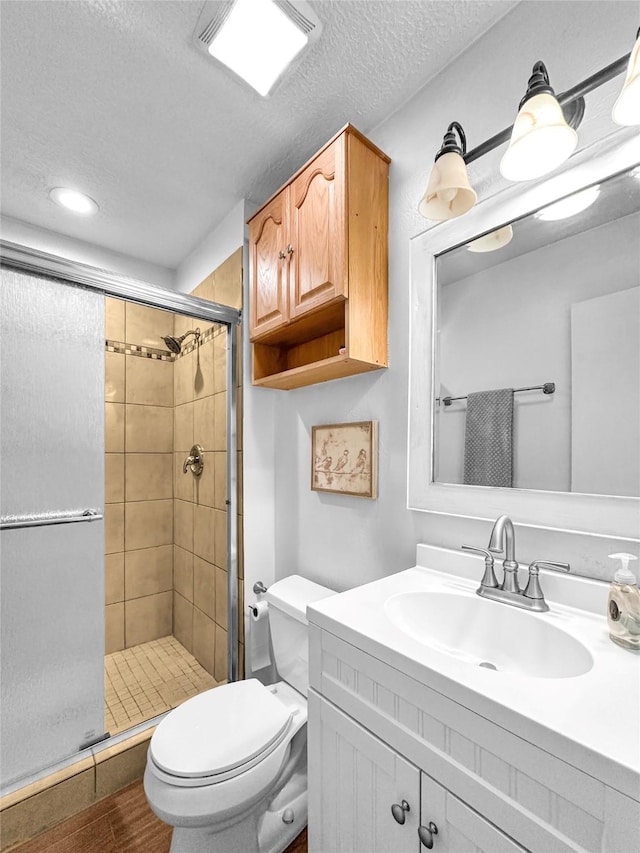 3301 Camino Prado Vis, Santa Fe, NM 87507 - full bath featuring a shower stall, vanity, a textured ceiling, and wood finished floors