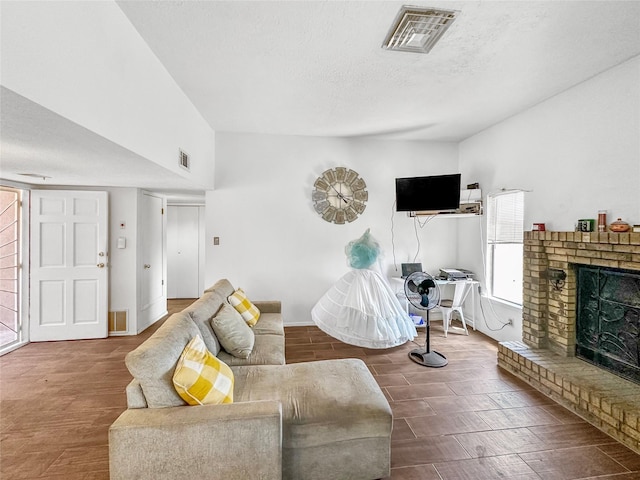 3301 Camino Prado Vis, Santa Fe, NM 87507 - living room featuring a fireplace, wood finished floors, and a textured ceiling