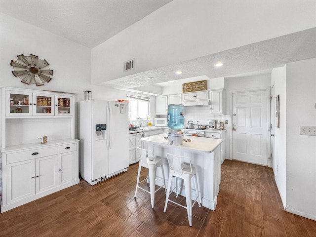 3301 Camino Prado Vis, Santa Fe, NM 87507 - kitchen featuring white appliances, white cabinetry, dark wood-style floors, light countertops, and a textured ceiling