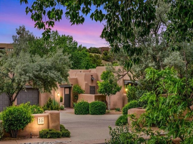 16 Plazuela Intimo, Santa Fe, NM 87506 - view of front of home featuring an attached garage and concrete driveway