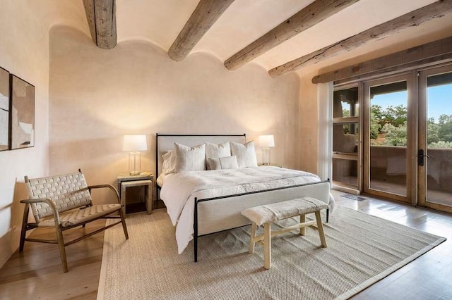 16 Plazuela Intimo, Santa Fe, NM 87506 - bedroom with access to outside, beam ceiling, and light wood-style flooring
