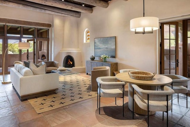 16 Plazuela Intimo, Santa Fe, NM 87506 - living room with beam ceiling, plenty of natural light, a lit fireplace, and french doors