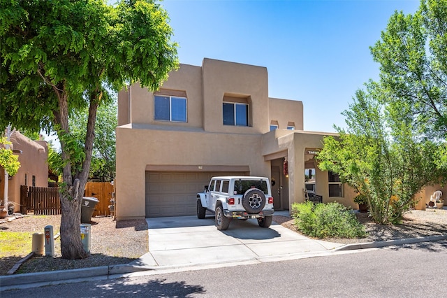 4737 Sundial Way, Santa Fe, NM 87507 - pueblo-style home with stucco siding, driveway, and an attached garage