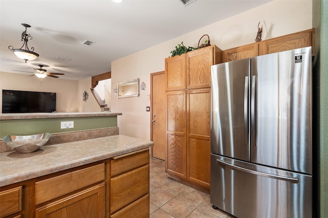 4737 Sundial Way, Santa Fe, NM 87507 - kitchen with freestanding refrigerator, a ceiling fan, light tile patterned floors, light countertops, and decorative light fixtures