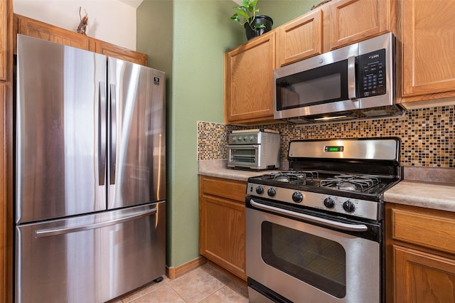 4737 Sundial Way, Santa Fe, NM 87507 - kitchen featuring appliances with stainless steel finishes, tasteful backsplash, light countertops, and light tile patterned floors