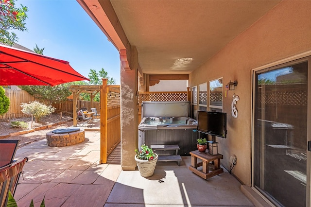 4737 Sundial Way, Santa Fe, NM 87507 - fenced backyard featuring a patio area, a fire pit, a hot tub, and a pergola
