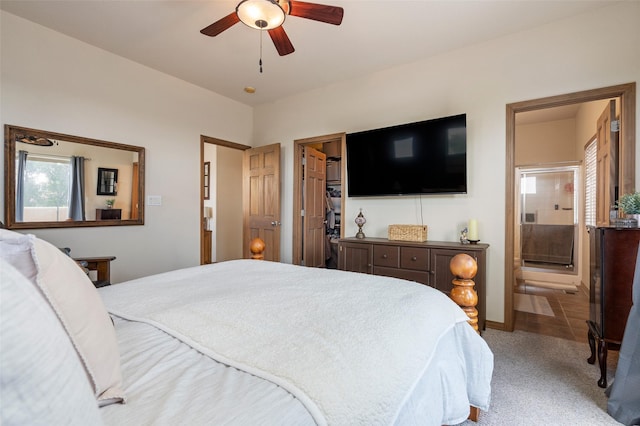 4737 Sundial Way, Santa Fe, NM 87507 - carpeted bedroom with connected bathroom, a spacious closet, and ceiling fan