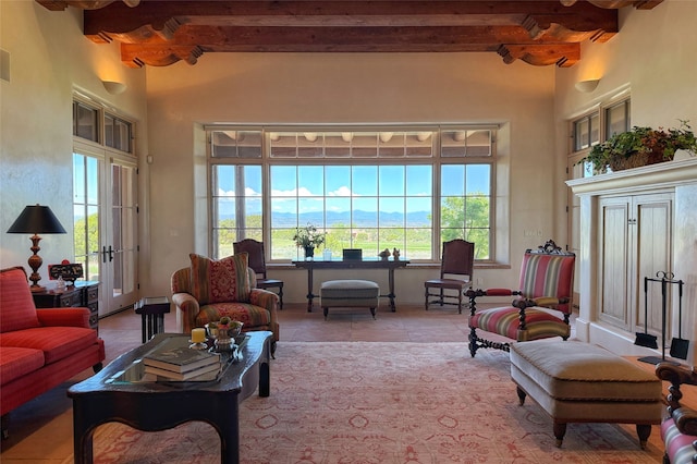 11 E Golden Eagle Rd, Santa Fe, NM 87506 - tiled living room featuring beamed ceiling, plenty of natural light, and a towering ceiling