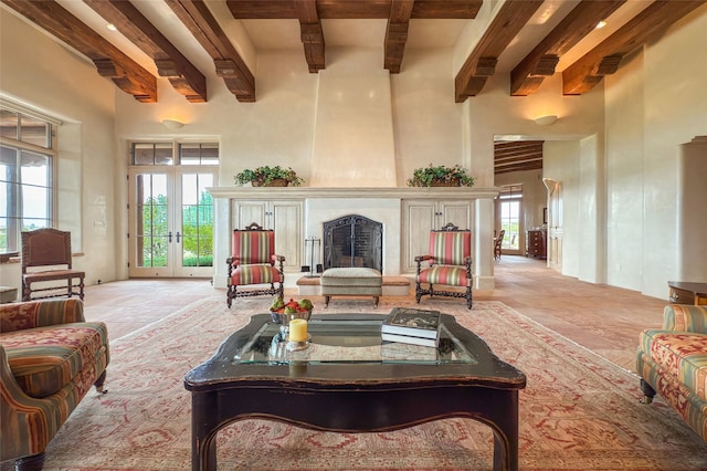11 E Golden Eagle Rd, Santa Fe, NM 87506 - living room featuring beam ceiling, a towering ceiling, a large fireplace, and french doors