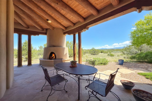 11 E Golden Eagle Rd, Santa Fe, NM 87506 - view of patio / terrace with a fireplace and outdoor dining space