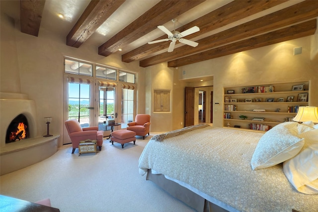 11 E Golden Eagle Rd, Santa Fe, NM 87506 - carpeted bedroom with access to outside, beamed ceiling, a large fireplace, and a high ceiling
