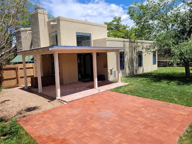 2730 La Silla Dorada, Santa Fe, NM 87505 - rear view of property with stucco siding, a patio area, and a chimney