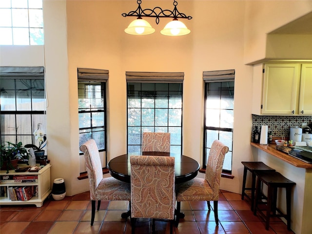 2730 La Silla Dorada, Santa Fe, NM 87505 - dining area with tile patterned flooring, healthy amount of natural light, and a high ceiling